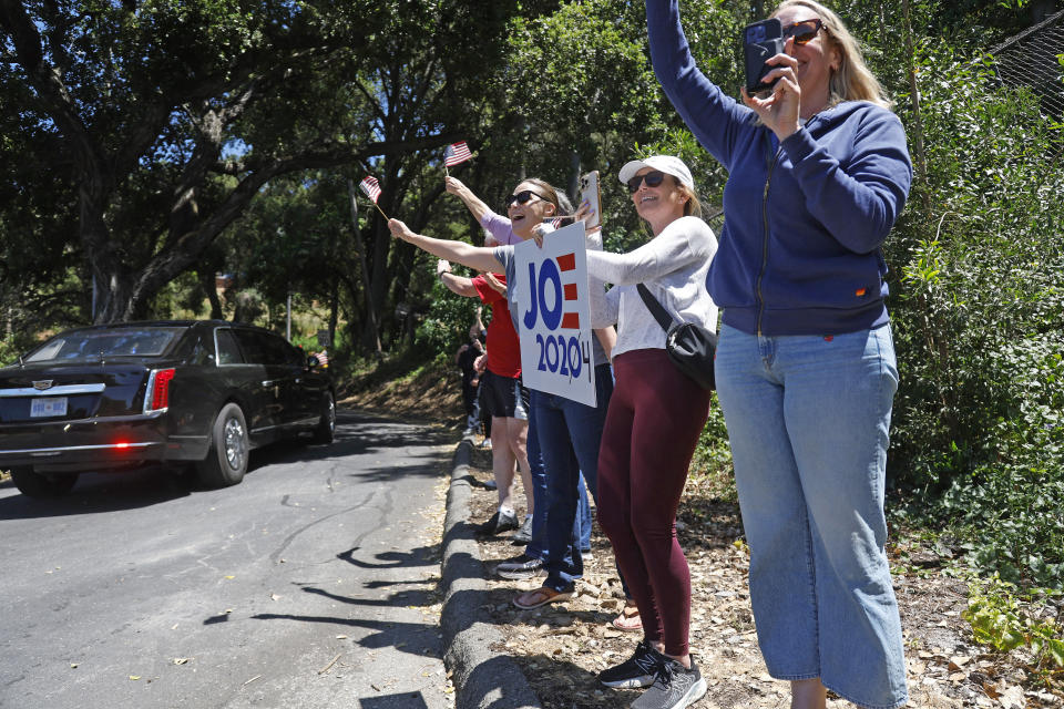 LOS GATOS, CALIFORNIA - JUNE 19: Supporters including Julia Berg, far right, and Lola Feldman, second from right, both from Los Gatos, wave at President Joe Biden's motorcade as it drives past Cypress Way and Phillips Ave on the way to a fundraiser in Los Gatos, Calif., on Monday, June 19, 2023. (Photo by Nhat V. Meyer/MediaNews Group/The Mercury News via Getty Images)