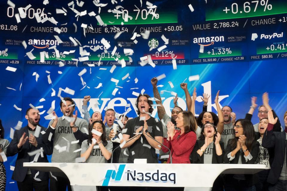 WeWork co-founder and CEO Adam Neumann, centre, attends the opening bell ceremony at Nasdaq in New York in this Jan. 16, 2018, file photo. When the company went public in 2021, it was valued at more than $9 billion US. (Mark Lennihan/The Associated Press - image credit)