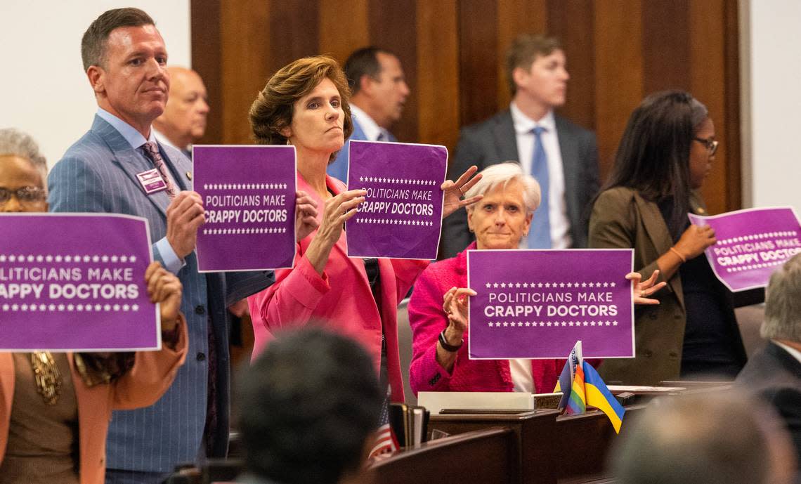 Democratic Senators hold signs after a vote on an abortion restrictions bill that was up for a veto override on Tuesday, May 16, 2023, at the Legislative Building in Raleigh, N.C. Republicans have a veto-proof supermajority in the General Assembly, with the ability to overturn a veto from Democratic Gov. Roy Cooper.