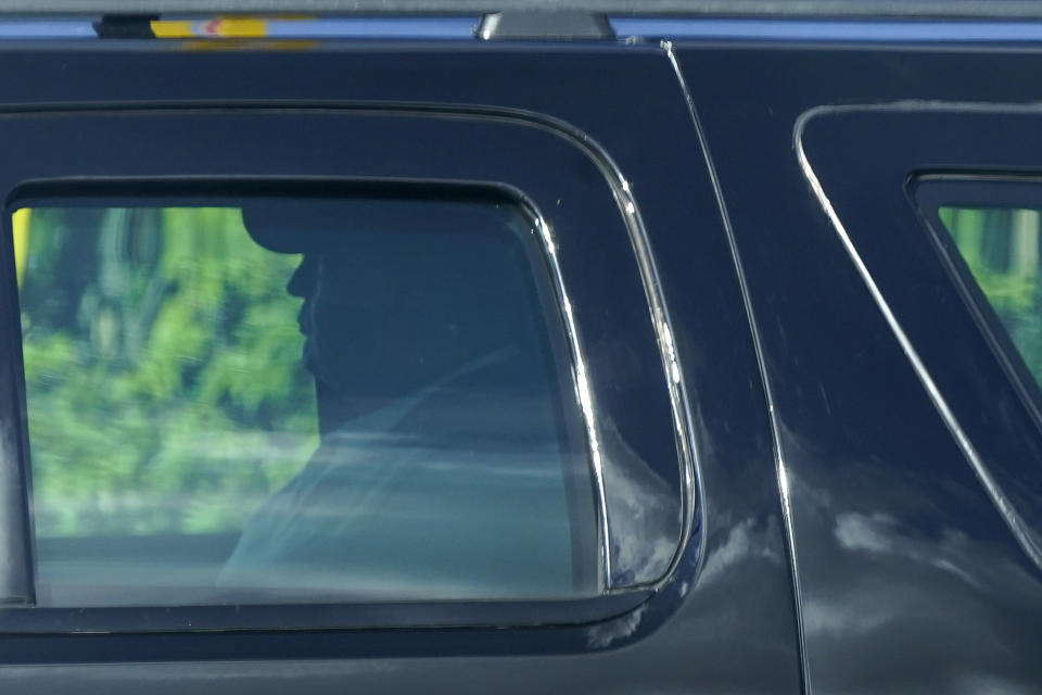 President Donald Trump rides in a motorcade vehicle as he departs his Mar-a-Lago resort, Sunday, Dec. 27, 2020, in Palm Beach, Fla. Trump is en route to Trump International Golf Club in West Palm Beach, Fla. (AP Photo/Patrick Semansky)