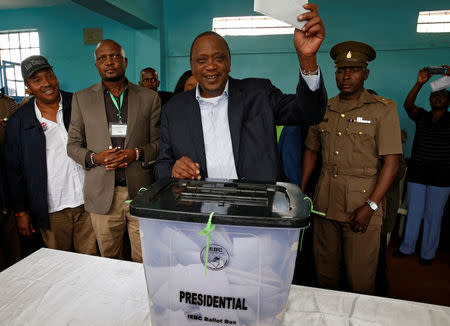 Kenya's President Uhuru Kenyatta casts his vote during a presidential election re-run in Gatundu, Kenya October 26, 2017. REUTERS/Siegfried Modola