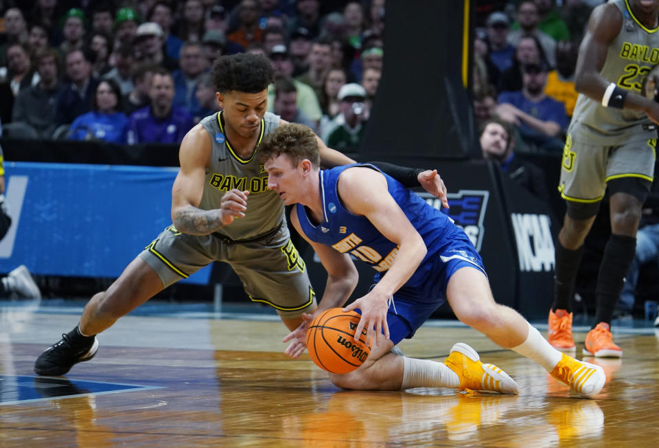 Baylor guard Keyonte George, left, and UC Santa Barbara guard Calvin Wishart battle for the ball in the second half of a first-round college basketball game in the men's NCAA Tournament Friday, March 17, 2023, in Denver. (AP Photo/John Leyba)