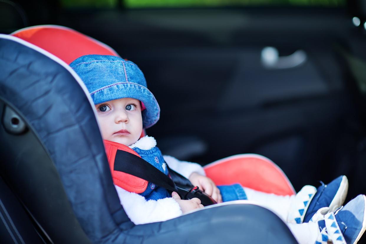 Baby in Car Seat With Blue Hat