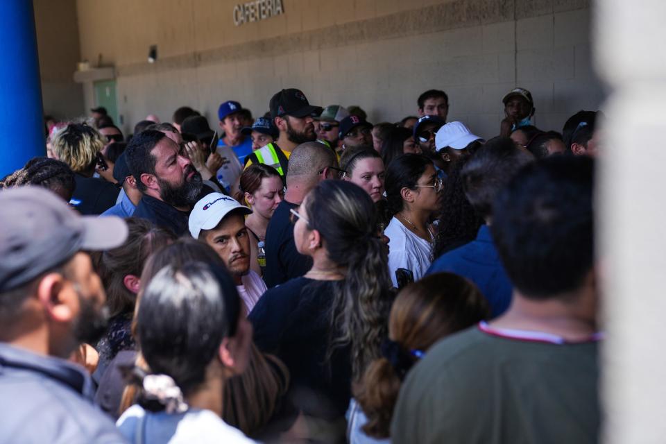 Parents wait in line to pick up their children from Thompson Ranch Elementary School in El Mirage after a lockdown on Aug. 12, 2022.