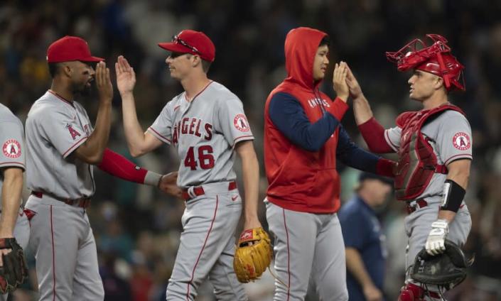 Los Angeles Angels players, from left, Jo Adell, Jimmy Herget, Shohei Ohtani and Max Stassi celebrate.