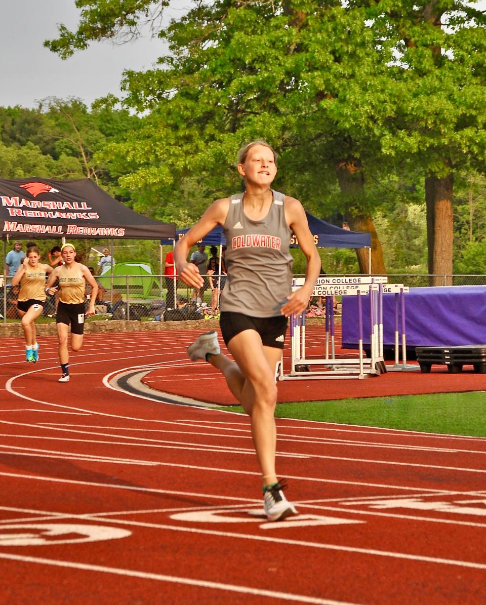 Coldwater's Grace Huff powers around the curve of the 200 meter dash Tuesday at the I-8 championship. Huff finished in fourth place in the race