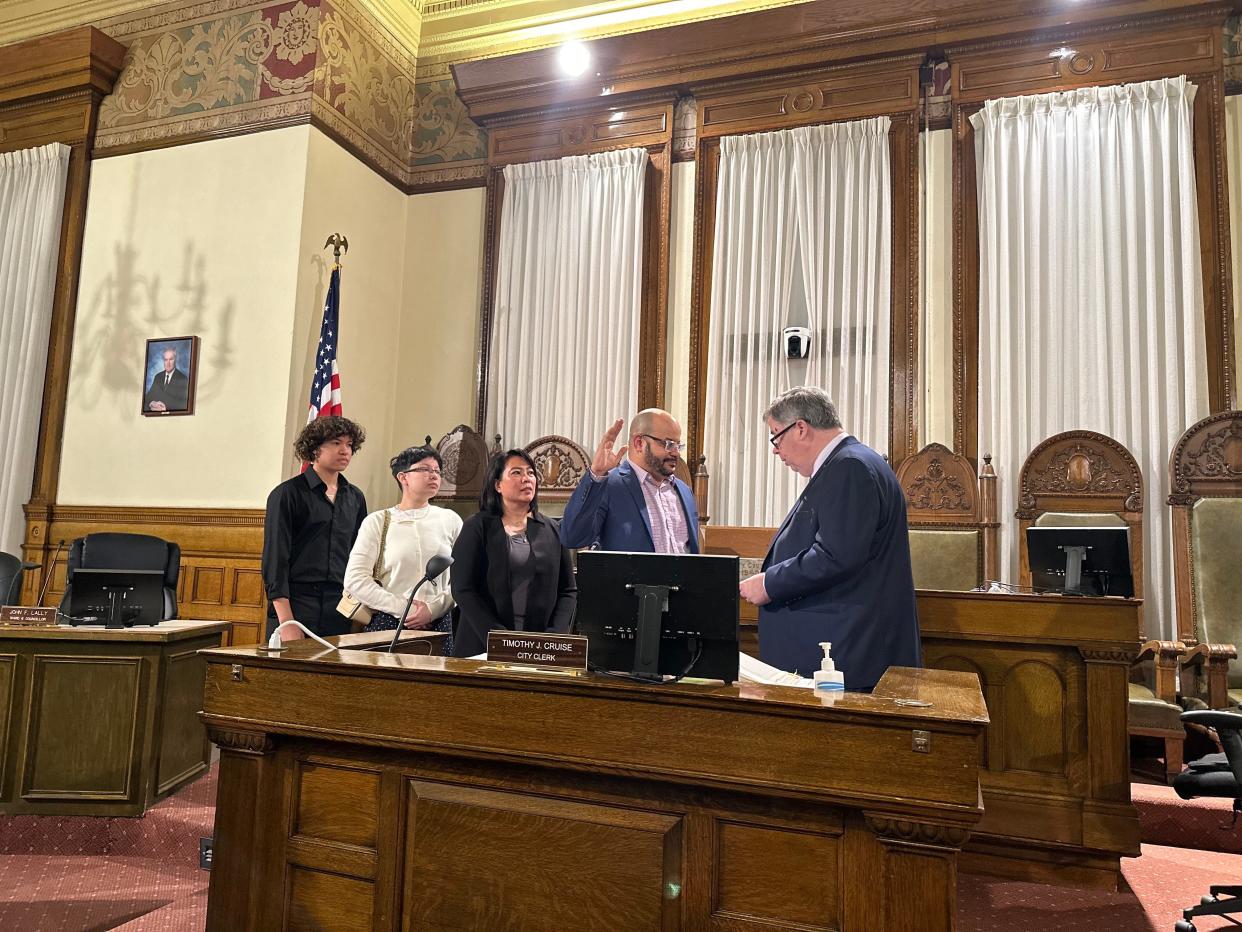 Jorge Vega, newly appointed Brockton School Committee member, stands with his family as he's sworn into office on April 11, 2024 at Brockton City Hall's City Council Chamber.