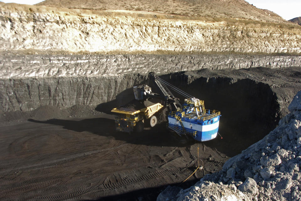 FILE - In this Nov. 15, 2016 photo, a mechanized shovel loads coal from an 80-feet thick seam into a truck at the Spring Creek mine near Decker, Mont. In a victory for President Joe Biden, a federal appeals court Thursday, April 14, 2022 refused to revisit its March decision reviving administration plans to account for potential damage from greenhouse gas emissions when creating rules for polluting industries. (AP Photo/Matthew Brown, File)