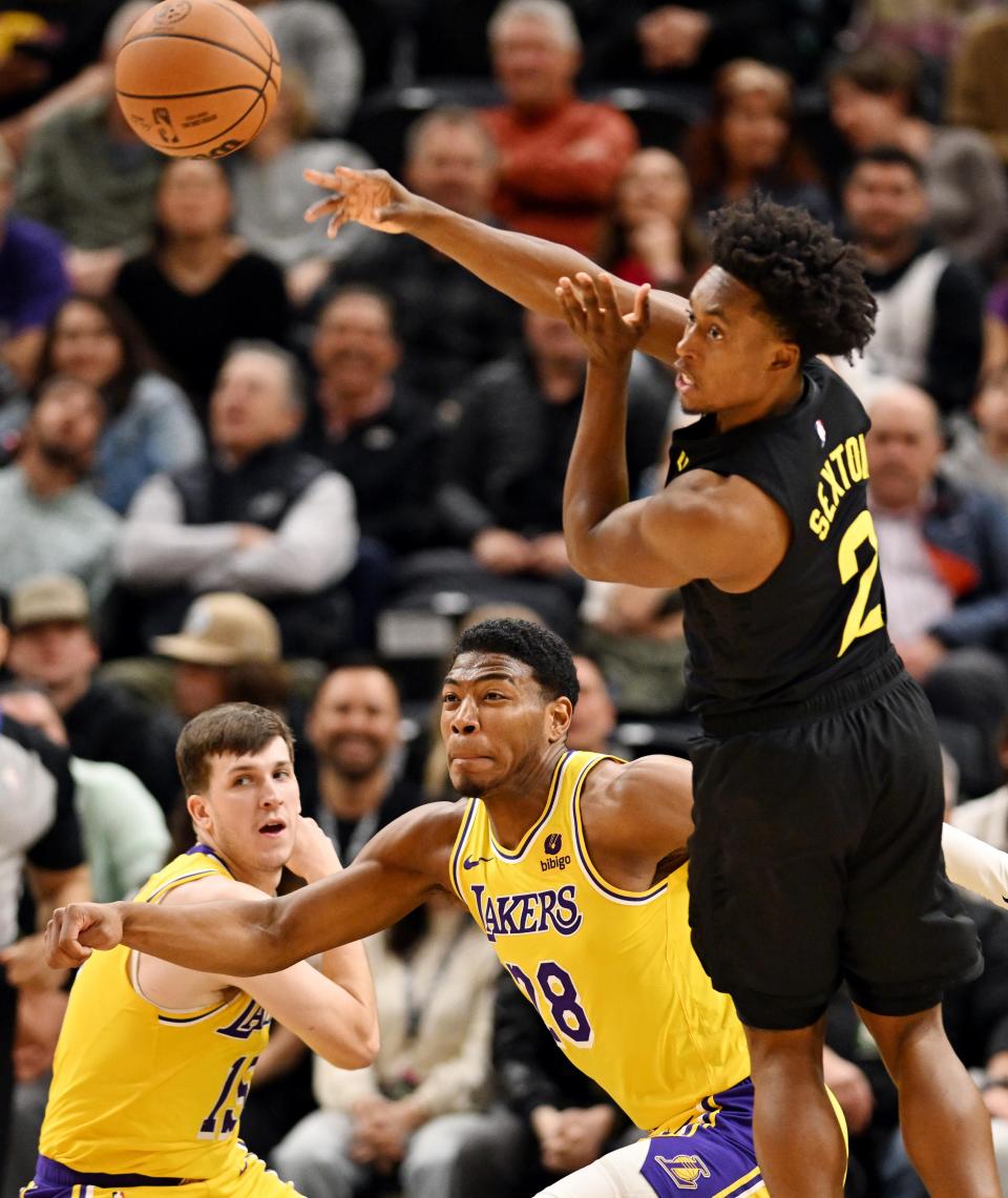 Utah Jazz guard Collin Sexton (2) flips the ball back as he is guarded by Los Angeles Lakers forward Rui Hachimura (28) as the Utah Jazz and the Los Angeles Lakers play at the Delta Center in Salt Lake City on 2/14/24. LA won 138-122. | Scott G Winterton, Deseret News