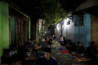 <p>Students sit outside as they learn Islamic scriptures in the evening during the holy month of Ramadan at Lirboyo Islamic boarding school in Kediri, Indonesia, May 24, 2018. (Photo: Beawiharta/Reuters) </p>