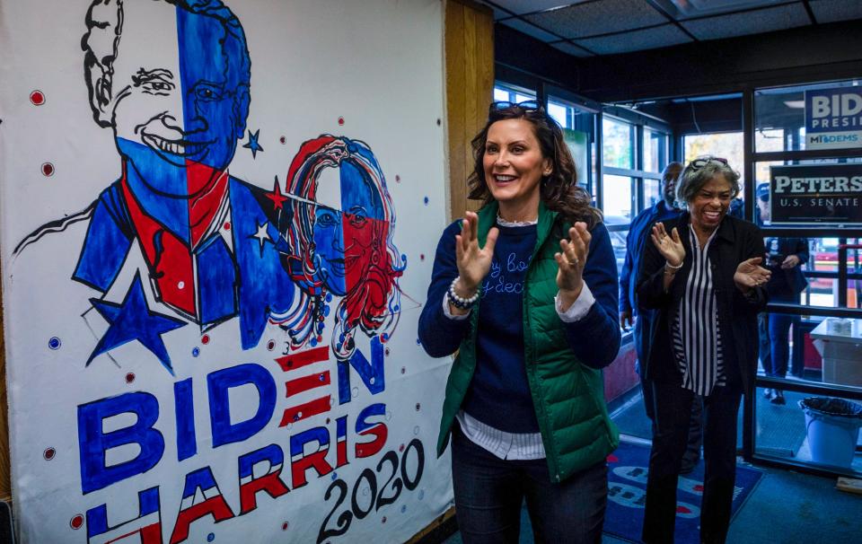 Gov. Gretchen Whitmer claps as she enters a room filled with community and news media members during a political event in Detroit on Tuesday, Nov. 8, 2022.