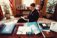 Former U.S. President Ronald Reagan prepares a speech at his desk in the Oval Office for a Joint Session of Congress on April 28, 1981. (Photo by Michael Evans/The White House/Getty Images)