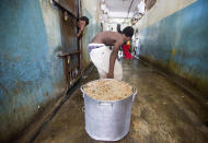 <p>A prisoner pulls a large stock pot filled with rice and beans during lunch inside the National Penitentiary in downtown Port-au-Prince, Hait, Feb. 13, 2017i. Prison authorities say they try their best to meet inmates’ needs, but repeatedly receive insufficient funds from the state to buy food and cooking fuel, leading to deadly cases of malnutrition-related ailments such as beriberi and anemia. (Photo: Dieu Nalio Chery/AP) </p>