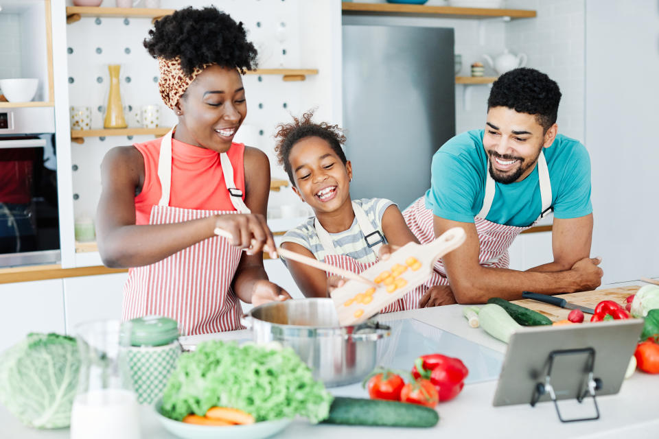 Family preparing meal and having fun in the kitchen at home