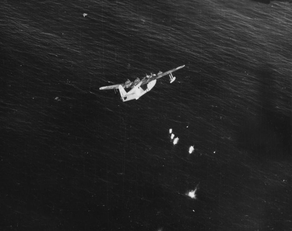 Lt. Guy M. Thompson Jr., of Patrol Bombing Squadron (VPB) 116 flies a Consolidated PB4Y-1 to protect <em>Salmon</em> during her return voyage, and detects and shoots down this Japanese Kawanishi H8K2 Type 2 Emily flying boat about 40 miles from the crippled submarine, November 1, 1944. <em>Naval History and Heritage Command</em>