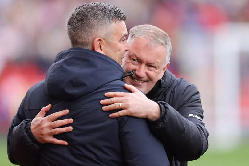 Steven Schumacher greets Neil Dewsnip before Stoke beat Plymouth in the Championship.