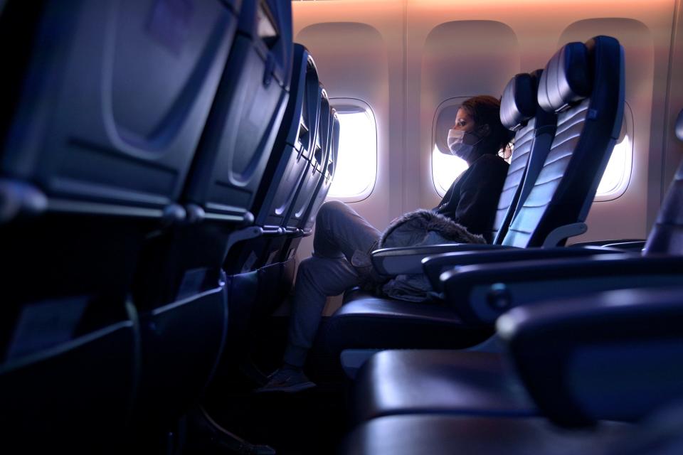 A masked passenger on a flight from San Francisco to Newark, N.J., on Oct. 27, 2020.