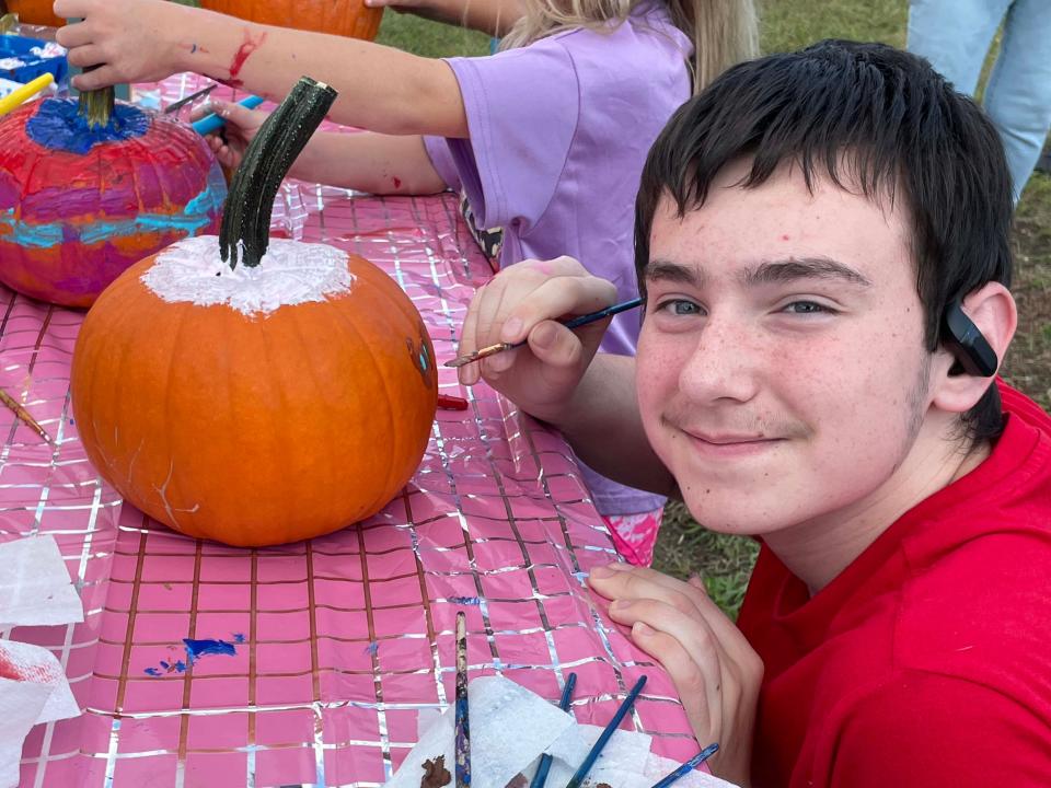 Donte Smith concentrates as he paints a pumpkin at the annual Family Festival.