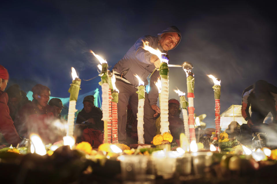 A devotee lights an oil lamp during the Bala Chaturdashi festival at the Pashupatinath Hindu temple in Kathmandu, Nepal, Monday, Nov. 21, 2022. (AP Photo/Niranjan Shrestha)