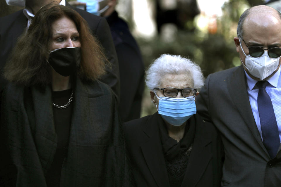 German Monika Borgmann, left, wife of Lokman Slim, a well-known Lebanese publisher and vocal critic of Hezbollah group, his mother Salma Mershak, center, and his brother Hadi slim, right, attend a memorial service to pay tribute to him, one week after he was found dead in his car with six bullets in his body, in the southern suburb of Beirut, Lebanon, Thursday, Feb. 11, 2021. Scores of friends and family members of the slain Lebanese publisher bid him farewell Thursday in a ceremony attended by western diplomats and organized in his home in the southern suburb of Beirut amid tight security. (AP Photo/Hussein Malla)