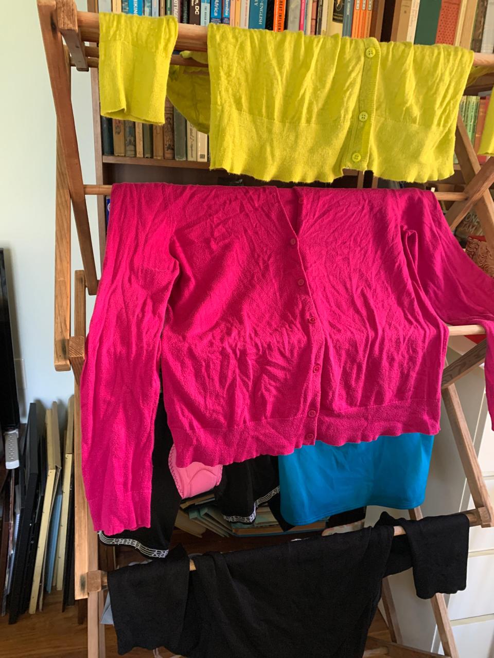 Clothes drying on a drying rack.