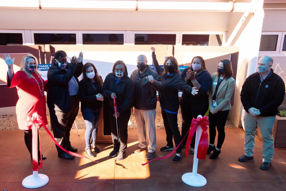 Those who were involved in the process of creating an outdoor classroom at Sabal Palm Elementary School cheer after Principal Anicia Robinson cuts the ribbon Tuesday, Jan. 19, 2021.