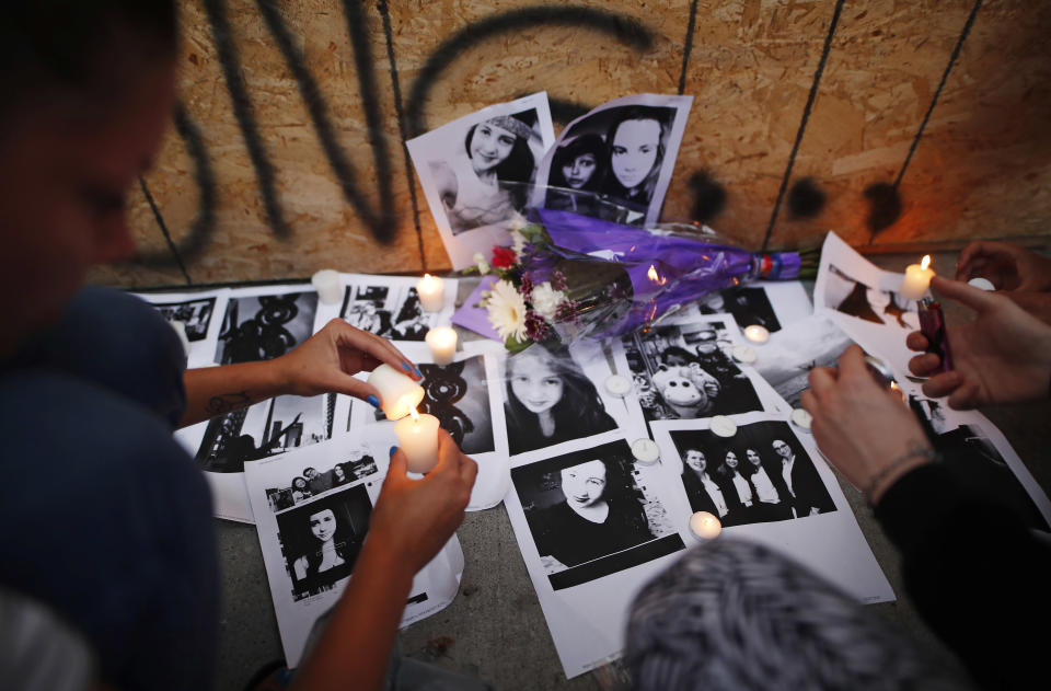 <p>People light candles and leave photos of 18-year-old victim Reese Fallon at a memorial remembering the victims of Sunday’s shooting in Toronto on Monday, July 23, 2018. (Photo: Mark Blinch/The Canadian Press via AP) </p>