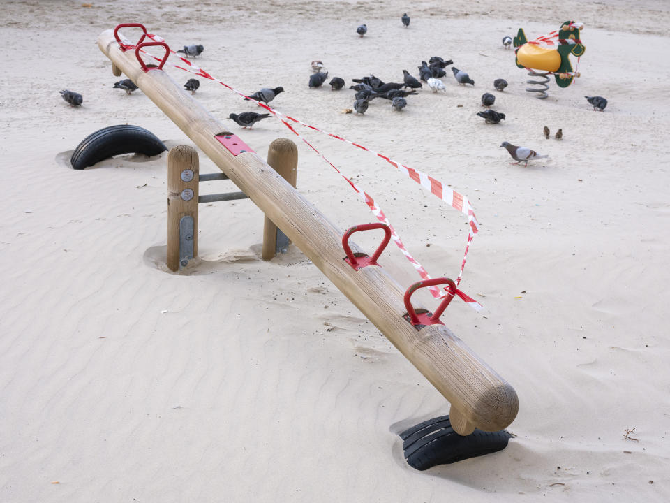 This Thursday, March 19, 2020 photo shows a seesaw at Tel Aviv's beachfront wrapped in tape to prevent public access. Israel has reported a steady increase in confirmed cases despite imposing strict travel bans and quarantine measures more than two weeks ago. Authorities recently ordered the closure of all non-essential businesses and encouraged people to work from home. (AP Photo/Oded Balilty)