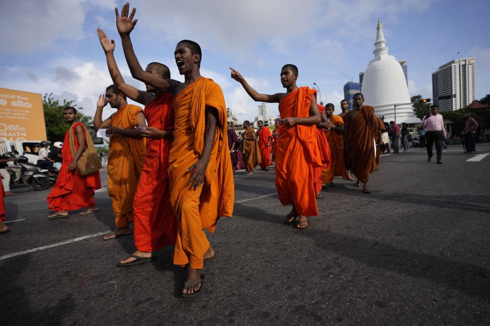 Sri Lankan student Buddhist monks shout slogans as they march demanding President Gotabaya Rajapaksa resign over the economic crisis in Colombo, Sri Lanka, Monday, June 20, 2022. (AP Photo/Eranga Jayawardena)