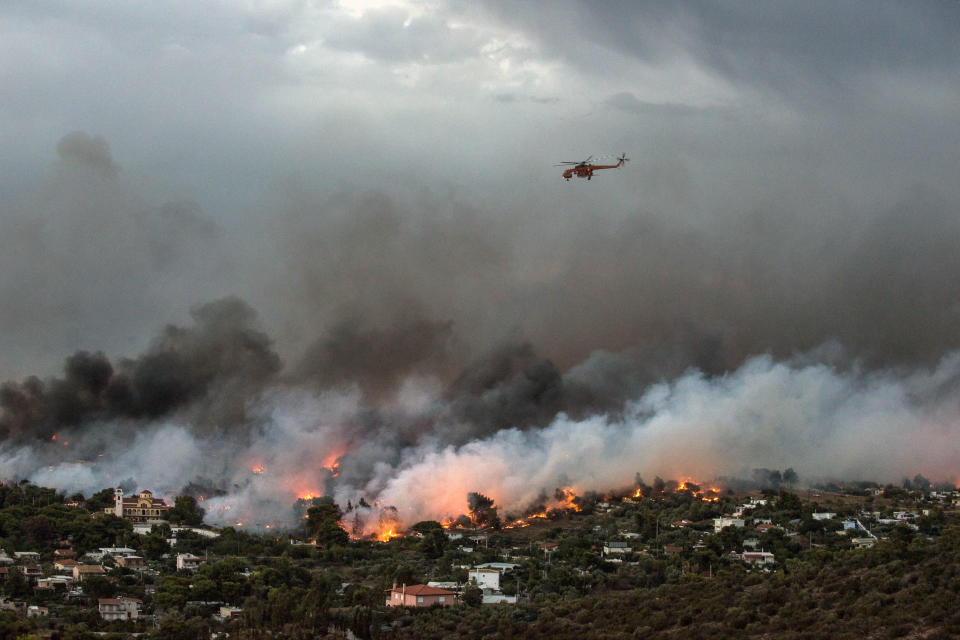 <p>Melted aluminium from cars is seen on the ground following a wildfire at the village of Mati, near Athens, Greece, July 24, 2018. (Photo: Costas Baltas/Reuters) </p>