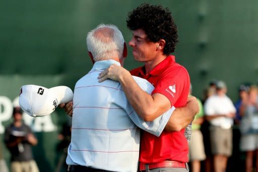 Rory McIlroy of Northern Ireland hugs his father Gerry McIlroy after winning the 94th PGA Championship at the Ocean Course, on August 12, in Kiawah Island, South Carolina. The 23-year-old Northern Irishman surpassed Luke Donald to become the No. 1 ranked player in the world as he closed with a six-under 66 in the final major championship of the season