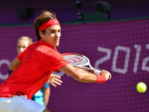 Switzerland's Roger Federer returns the ball to Great Britain's Andy Murray during the men's singles gold medal match