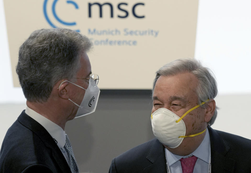 Christoph Heusgen, left, Chairman of the Board of Trustees, Munich Security Conference Foundation, and United Nations Secretary-General Antonio Guterres, right, talk during the 'Munich Security Conference' in Munich, Germany, Friday, Feb. 18, 2022. (AP Photo/Michael Probst)