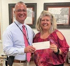 Charis Burger, who received a grant from the Greenville Federal Credit Union, with Principal Mike Peake of Mauldin High School.