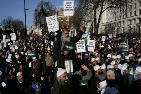 Muslim demonstrators hold placards during a protest against the publication of cartoons depicting the Prophet Mohammad in French satirical weekly Charlie Hebdo, near Downing Street in central London February 8, 2015. REUTERS/Stefan Wermuth