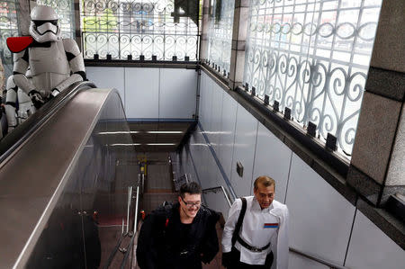 Fans dressed as the characters from "Star Wars" leave from the Taipei Metro (MRT) during Star Wars Day in Taipei, Taiwan May 4, 2017. REUTERS/Tyrone Siu