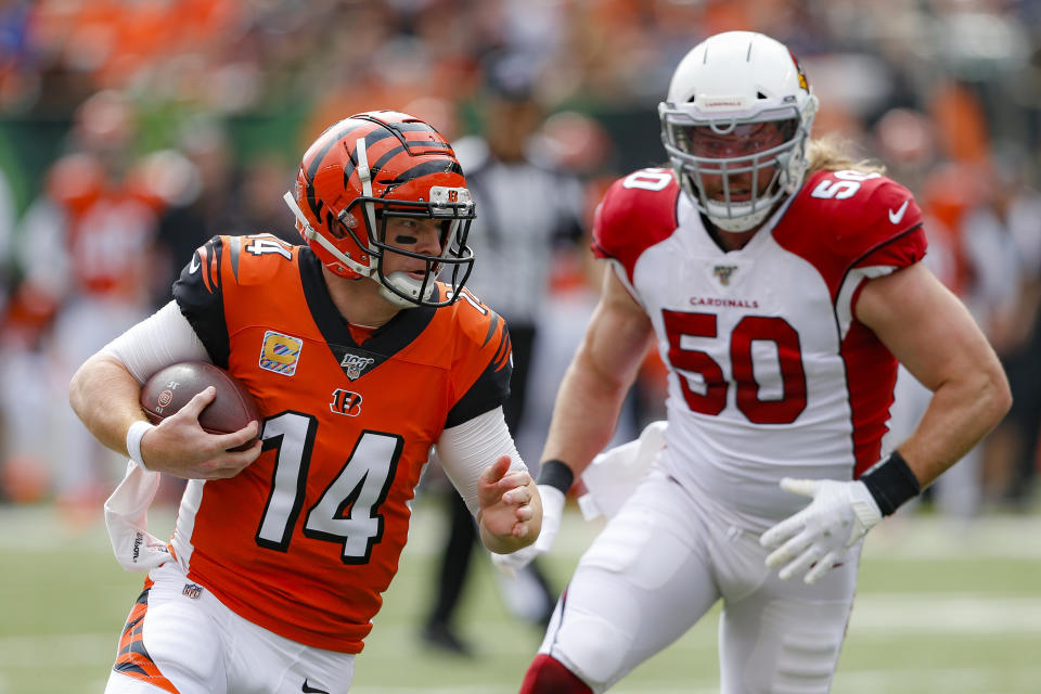 Cincinnati Bengals quarterback Andy Dalton (14) runs the ball past Arizona Cardinals linebacker Brooks Reed (50) in the first half of an NFL football game, Sunday, Oct. 6, 2019, in Cincinnati. (AP Photo/Gary Landers)