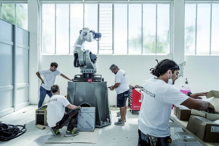 Technicians assemble a robot at the Robotor company in Carrara, Italy on June 30, 2021. Using the same marble found in Renaissance masterpieces, a team of robots is accepting commissions. Their owners say tech is essential to Italy√¢ˇÊ¨‚Ñ¢s artistic future. (Alessandro Grassani/The New York Times)