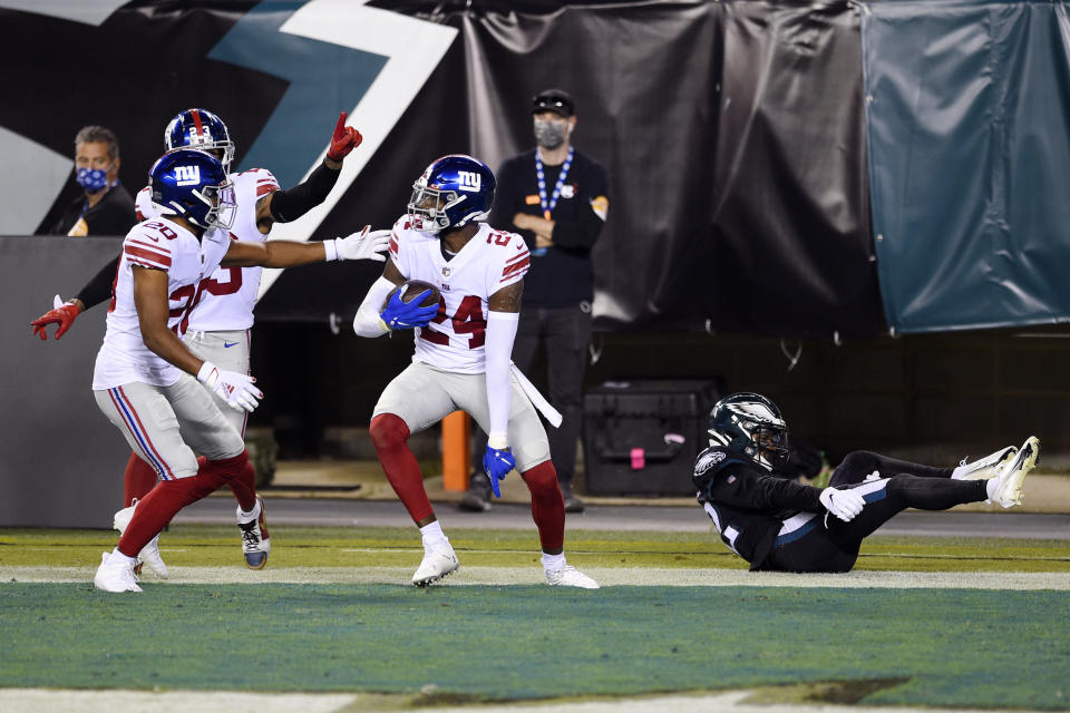 New York Giants' James Bradberry (24) reacts with teammates after intercepting a pass during the first half of an NFL football game against the Philadelphia Eagles, Thursday, Oct. 22, 2020, in Philadelphia. (AP Photo/Derik Hamilton)