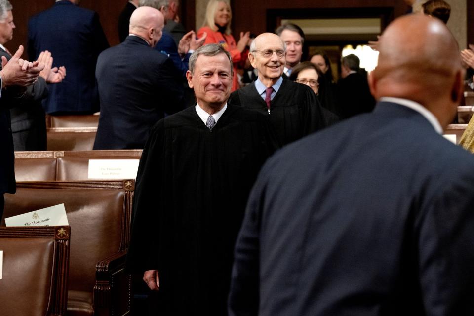 Supreme Court Chief Justice John Roberts, center, and Justice Stephen Breyer arrive for the State of the Union address by President Joe Biden at the U.S. Capitol on March 1.
