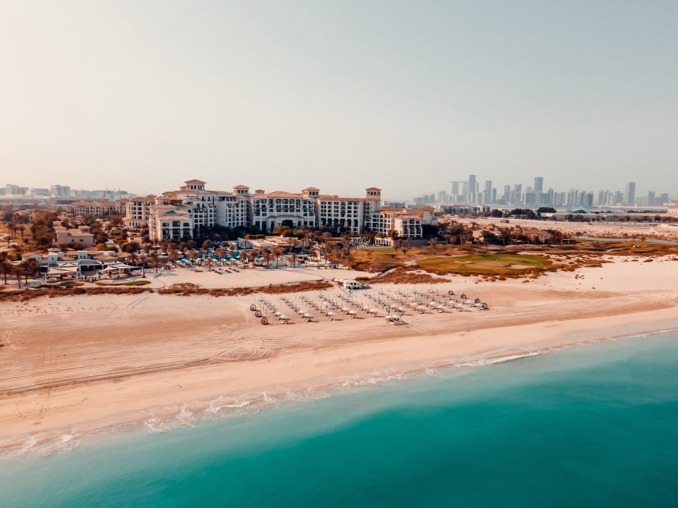 a beach with buildings in the background