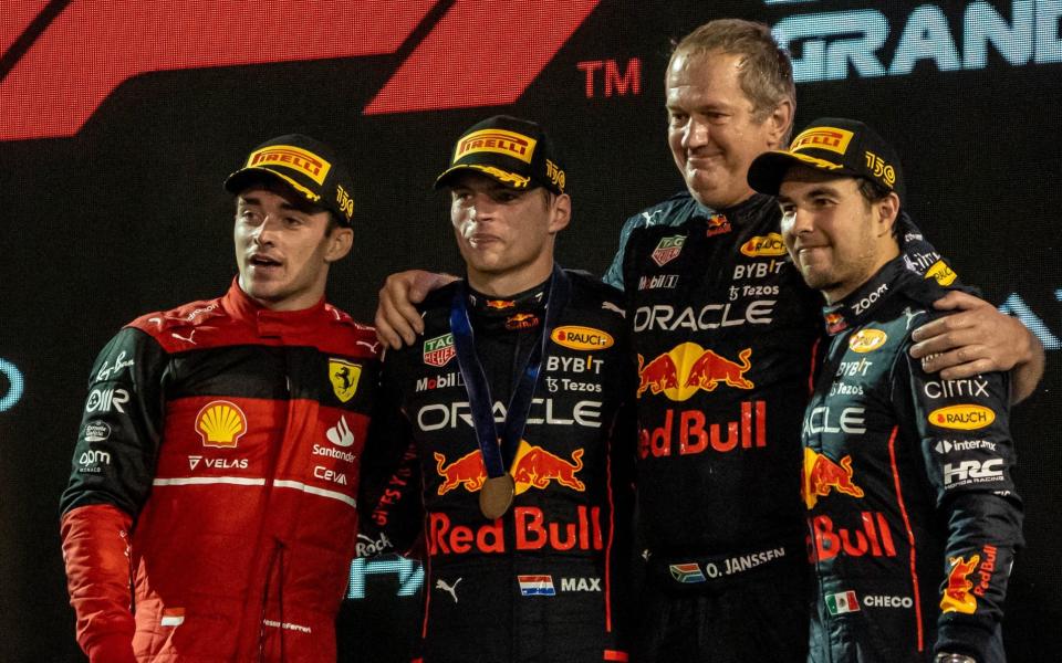 First place winner Max Verstappen (2nd L) of Red Bull, second place winner Charles Leclerc (L) of Ferrari and the third place winner Sergio Perez (R) of Red Bull pose for a photo on the podium during the F1 Grand Prix of Abu Dhabi - Anadolu