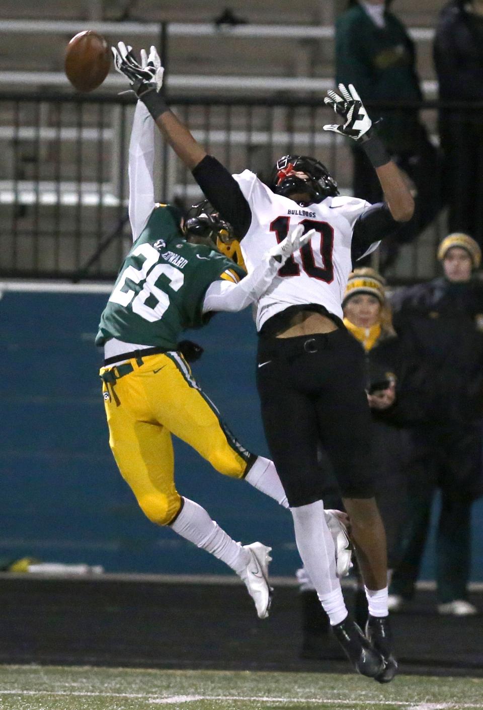 Cynceir McNeal, 10, of McKinley reaches for a pass while being covered by Carlton Landingham II, 26, of St. Edward during their DI regional semifinal game at Parma on Friday, Nov. 12, 2021.