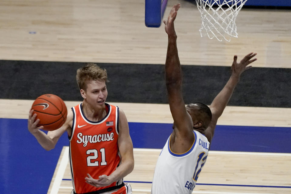 Syracuse's Marek Dolezaj, left, looks to pass as Pittsburgh's Abdoul Karim Coulibaly (12) defends during the second half of an NCAA college basketball game, Saturday, Jan. 16, 2021, in Pittsburgh. Pittsburgh won 96-76. (AP Photo/Keith Srakocic)