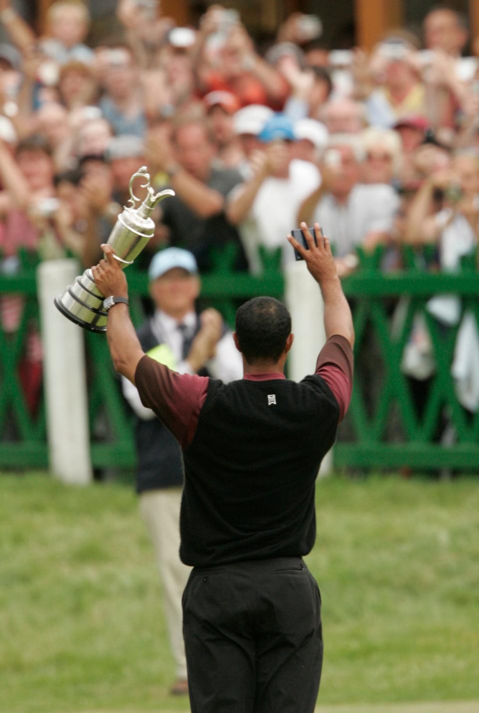 July 17, 2005 -- Tiger Woods waves to fans while holding up the Claret Jug after winning the British Open at St. Andrews.