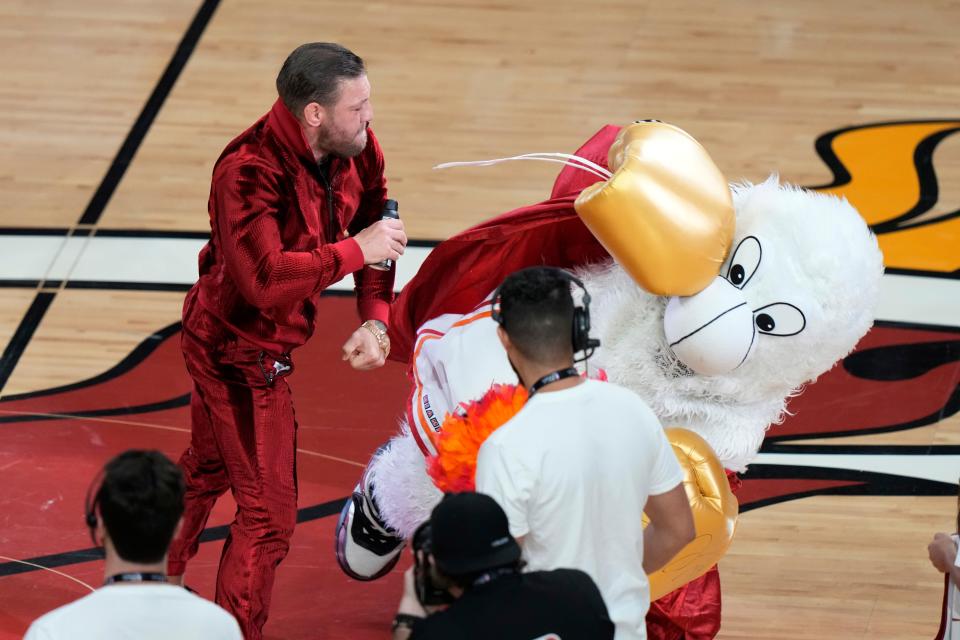 Conor McGregor punches Burnie, the Miami Heat mascot, during a break during Game 4 of the NBA Finals.