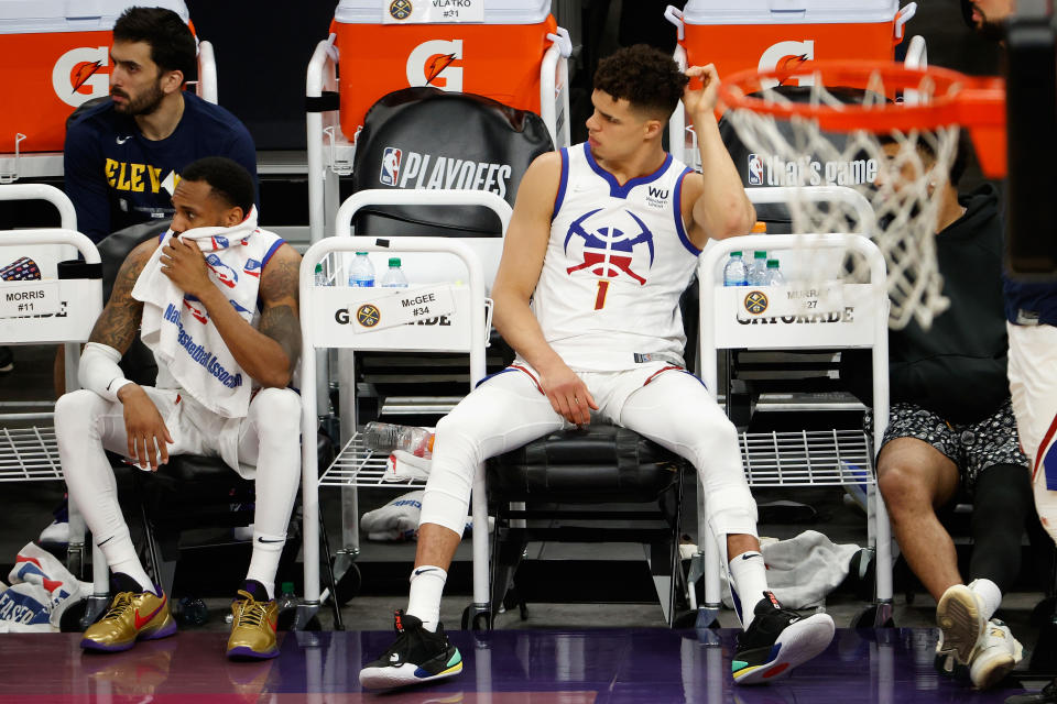 Michael Porter Jr. and Monte Morris look dejected while sitting on the bench.