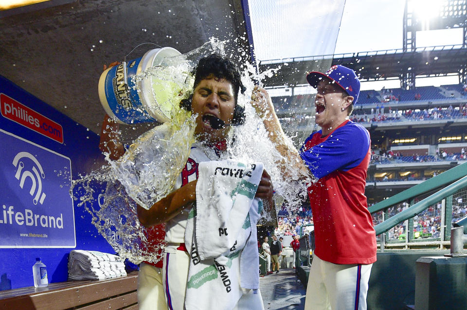 Philadelphia Phillies starting pitcher Ranger Suarez is doused in the dugout by teammates after a victory against the Pittsburgh Pirates, Saturday, Sept. 25, 2021, in Philadelphia. The Phillies won 3-0. (AP Photo/Derik Hamilton)