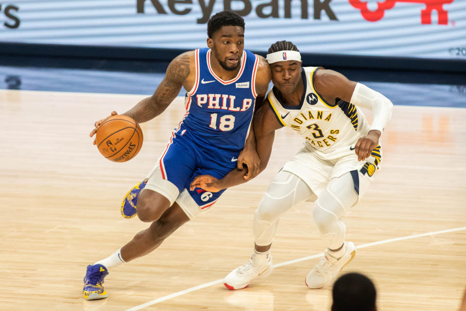 Dec 18, 2020; Indianapolis, Indiana, USA; Philadelphia 76ers guard Shake Milton (18) dribbles the ball while Indiana Pacers guard Aaron Holiday (3) defends in the second quarter at Bankers Life Fieldhouse.