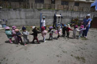 Children play during recess at a government-run daycare where they are fed one meal at lunch time in Catzuqui de Velasco, a rural area without reliable basic services like water and sewage, on the outskirts of Quito, Ecuador, Thursday, Dec. 1, 2022. Child malnutrition is chronic among Ecuador's 18 million inhabitants, hitting hardest in rural areas and among the country's Indigenous, according to Erwin Ronquillo, secretary of the government program Ecuador Grows Without Malnutrition. (AP Photo/Dolores Ochoa)